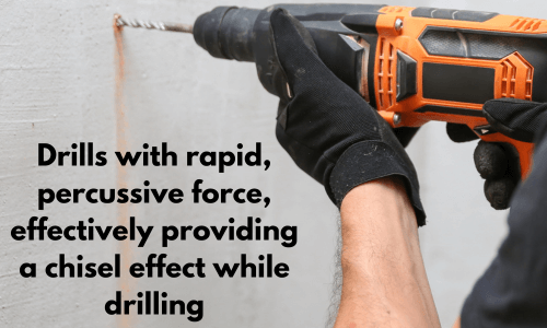 A worker using a hammer drill with rapid percussive force to drill into a concrete wall.